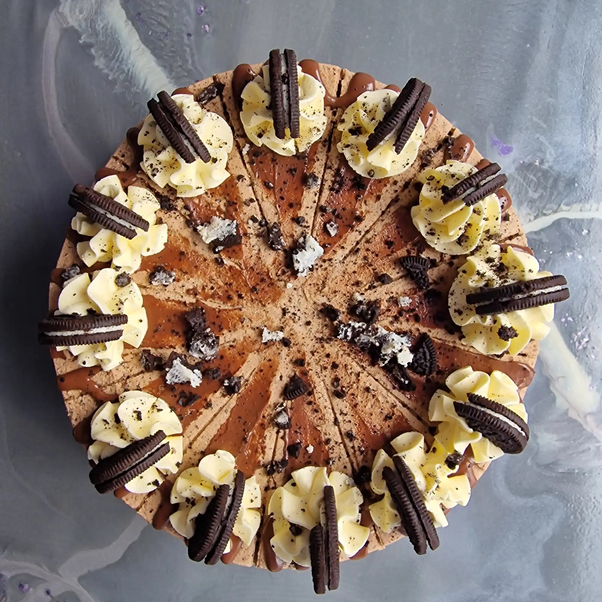 Oreo cheesecake with whipped cream and cookie garnish.